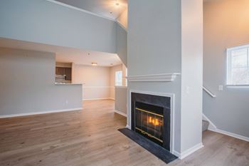 the living room has a fireplace and a hardwood floor